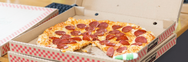 A close-up view of a pizza box with a missing slice.